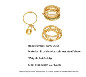 Macro shot of gold stainless steel rings set with micro-pave zircons and lock key pendants
