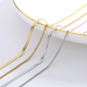 Detailed macro view of gold and silver flat snake chains and twisted curb chains