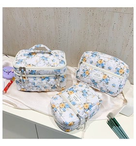 Three-piece floral makeup bag set with quilted texture and sturdy handles for travel