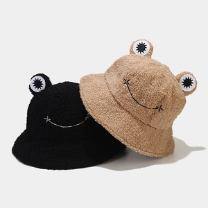 Detailed view of plush frog bucket hats in black and khaki with cute embroidery
