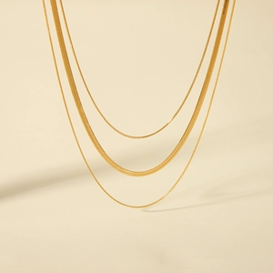 Close-up of triple-layered 18K gold-plated stainless steel snake and blade chains