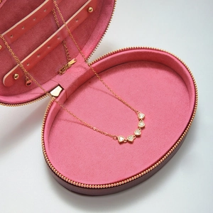18K gold heart-shaped zircon necklace displayed in a pink velvet jewelry box