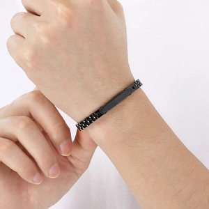 Close-up of a black stainless steel industrial link bracelet with flat metal bar on wrist