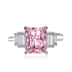 Luxury pink rectangular zircon ring with side stones on a reflective white background
