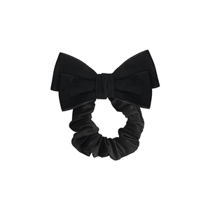 Elegant black velvet bow hair scrunchie in French retro style on white background