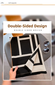 Detail view of the double-sided thick black and white geometric scarf with fringe edges