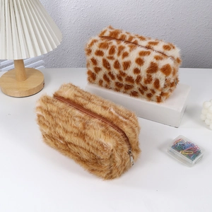 Detailed view of plush pouch featuring giraffe pattern and solid brown faux fur texture