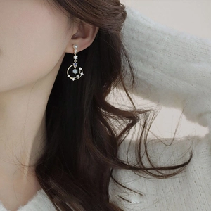 Asymmetric long tassel earrings with pearls and moon star charms in gold finish