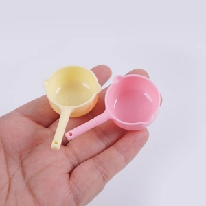 Miniature pink and yellow plastic frying pans for dollhouse kitchen accessories