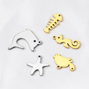 Detail of stainless steel marine charms in dolphin and starfish shapes for DIY jewelry