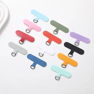 Flat lay of colorful universal T-shaped phone tether tabs with durable metal D-rings
