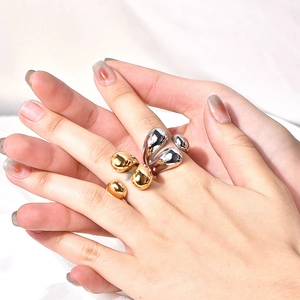Macro view of fluid liquid metal ring in mixed gold and silver high polish finish