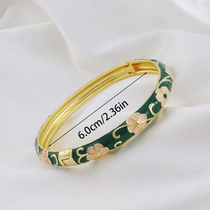 Detailed view of dark green enamel flower bangle with 6.0cm inner diameter measurement