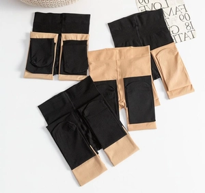 Detail of folded black and beige拼接 stitching tights displayed on white background