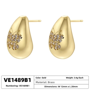 Detail of gold brass teardrop earrings with butterfly crystals, 12x20mm size and 3.4g weight