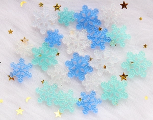 Sparkly resin snowflake charms in white and blue for DIY jewelry and hair accessories