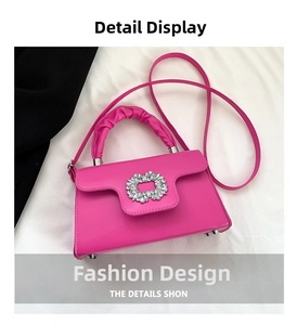 Detail of fuchsia PU leather crossbody bag with rhinestone buckle and pleated handle