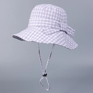 Detail of purple and white plaid sun hat with a decorative bow and adjustable wind cord