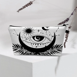 Detail of waterproof evil eye cosmetic bag with celestial sun and moon graphics