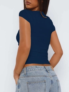 Back view of a slim fit deep blue cropped knitted T-shirt on a female model with jeans