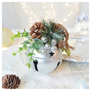 Close-up of silver Christmas bell with pine cones and green needles on snow background