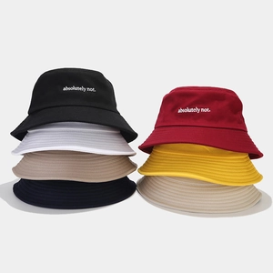 Detail showing colorful cotton bucket hats with 'absolutely not' embroidery and stitching