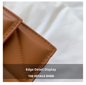 Macro shot of precise stitching and oil-edge finish on brown leather crossbody bag