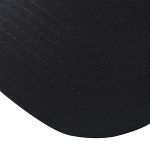 Close-up of black cotton twill fabric showing dense texture and curved stitching detail
