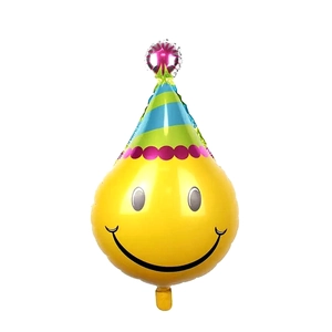 Detail of party hat shaped foil balloon with a yellow smiley face and colorful stripes
