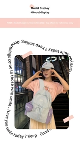 Blue and purple nylon backpack with heart charm shown on a model in a casual setting