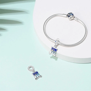 Close-up of silver beaded bracelet with Starry Night oil painting enamel pendant