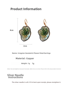 Macro view of irregular floral resin drop earrings with copper hooks and size measurements