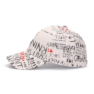 Detailed side view of beige baseball cap with black and red graffiti letter printing