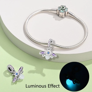 Luminous firefly charm pendant with colorful zircons on snake bone bracelet showing glowing effect