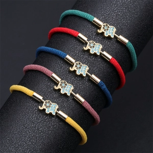 Detail of colorful braided elephant bracelets with blue and black zircon inlay