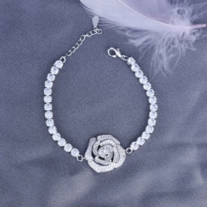 Detail of silver S925 bracelet featuring a sparkling rose pendant with zircon stones