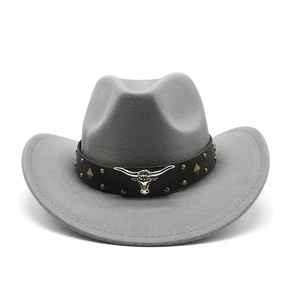 Detail of grey felt cowboy hat with silver bull head emblem and metallic rivets decoration