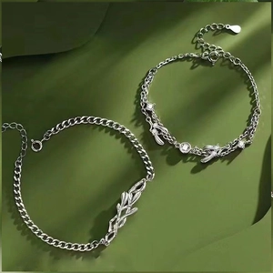 Detailed close-up of a silver mistletoe leaf bracelet set with shimmering zircon stones