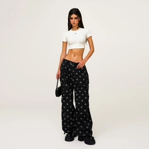 Women's streetwear set with a white crop top and black printed cargo paratrooper pants