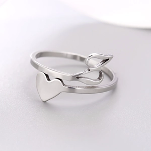 Close-up of heart and leaf intertwined design on a silver stainless steel ring band