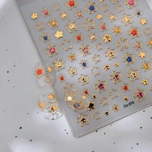Golden holographic star nail art stickers Co-370 with colorful hollow designs on white background