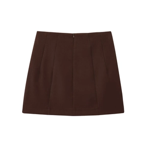 Detail of a dark brown A-line mini skirt featuring vertical seams and hidden back zipper