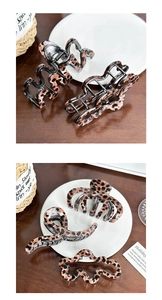 Detailed view of assorted leopard print claw clips and hair accessories on a white plate