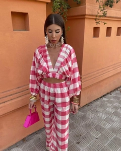 Detailed view of pink plaid two-piece set featuring V-neck crop top and wide-leg trousers
