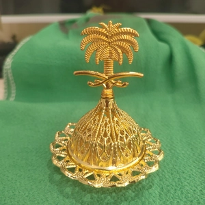 Golden palm tree incense burner with ornate hollowed base in Middle Eastern style