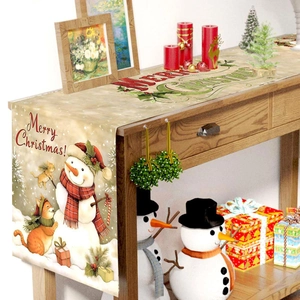 Christmas table runner with snowman and cat pattern on a wooden decorative table
