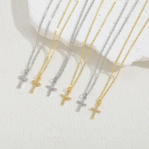 Cross and lightning bolt zircon necklaces in gold and silver finish on stone