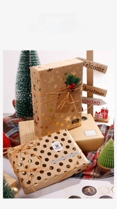 Detail of Christmas brown kraft paper gift wrap with gold foil stars and twine
