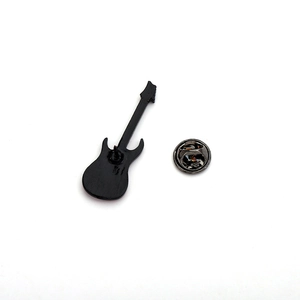 Detail of a black guitar enamel pin featuring a classic metal butterfly clutch back