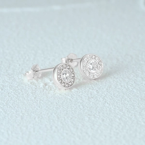Macro shot of 925 sterling silver C-shaped earrings with round-cut pavé diamonds